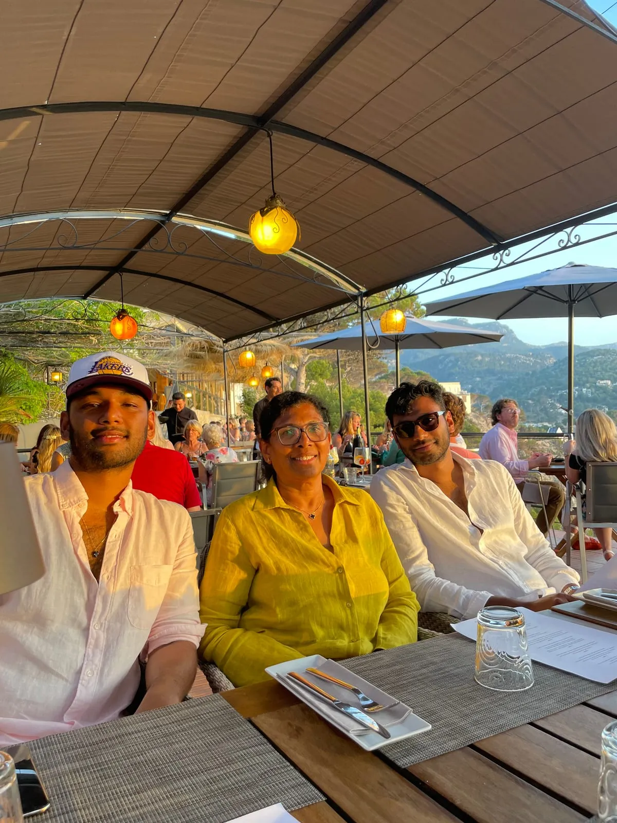 Dinner for three on a restaurant terrace at sunset